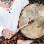 woman beating a drum